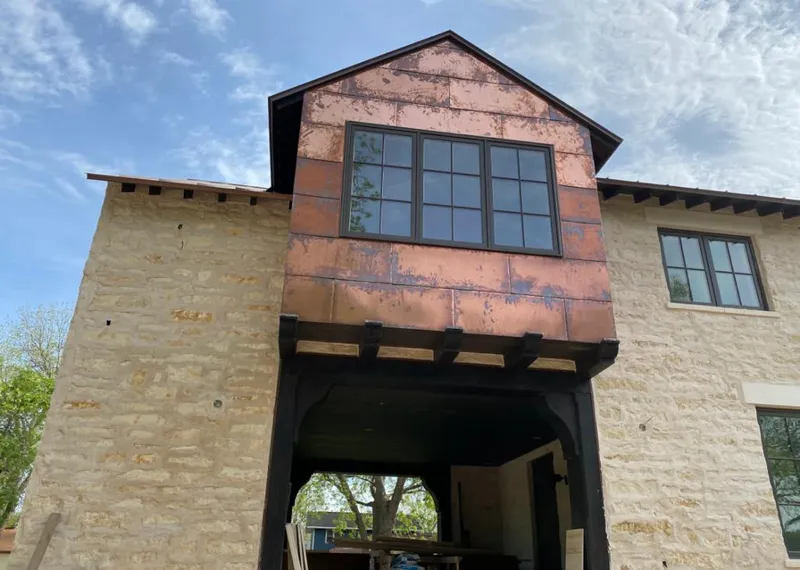 Copper metal panel facade on a stone building for Skylight Installation in Mount Prospect